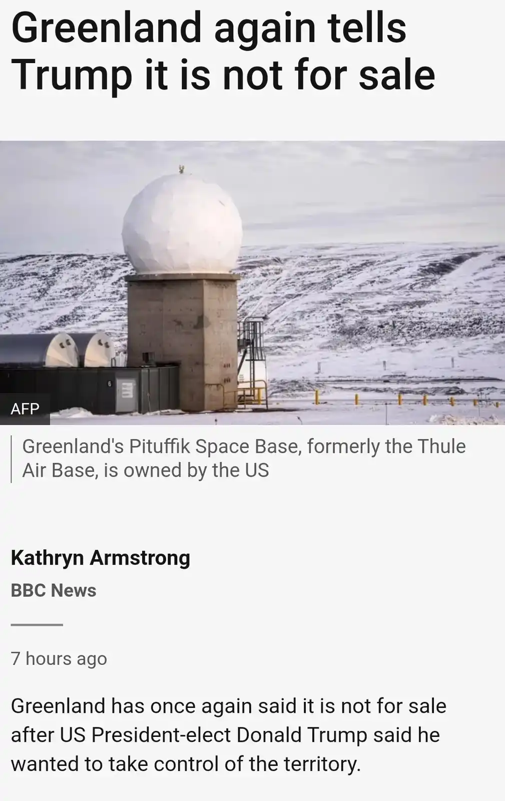 The image shows a snowy landscape with a large white radome atop a concrete structure, identified as Greenland's Pituffik…