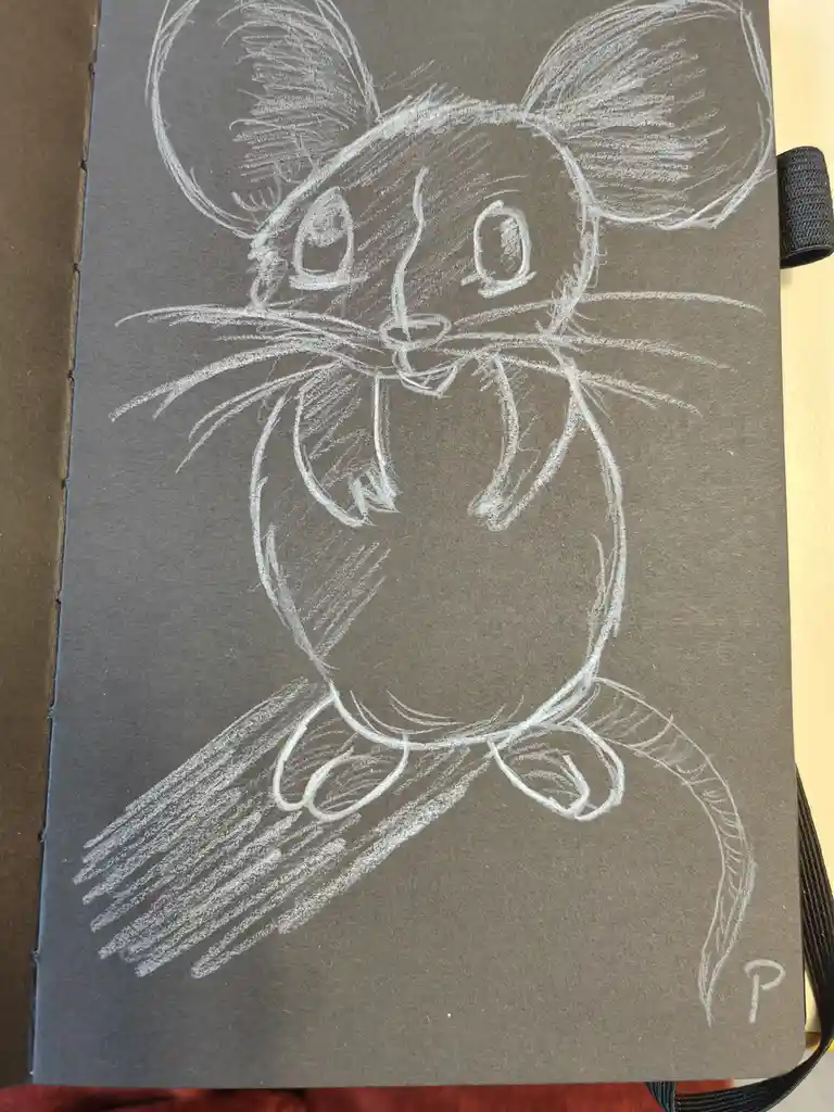 A white chalk drawing of a cartoon mouse with large ears, big eyes, whiskers, and a long tail on dark gray notebook paper…