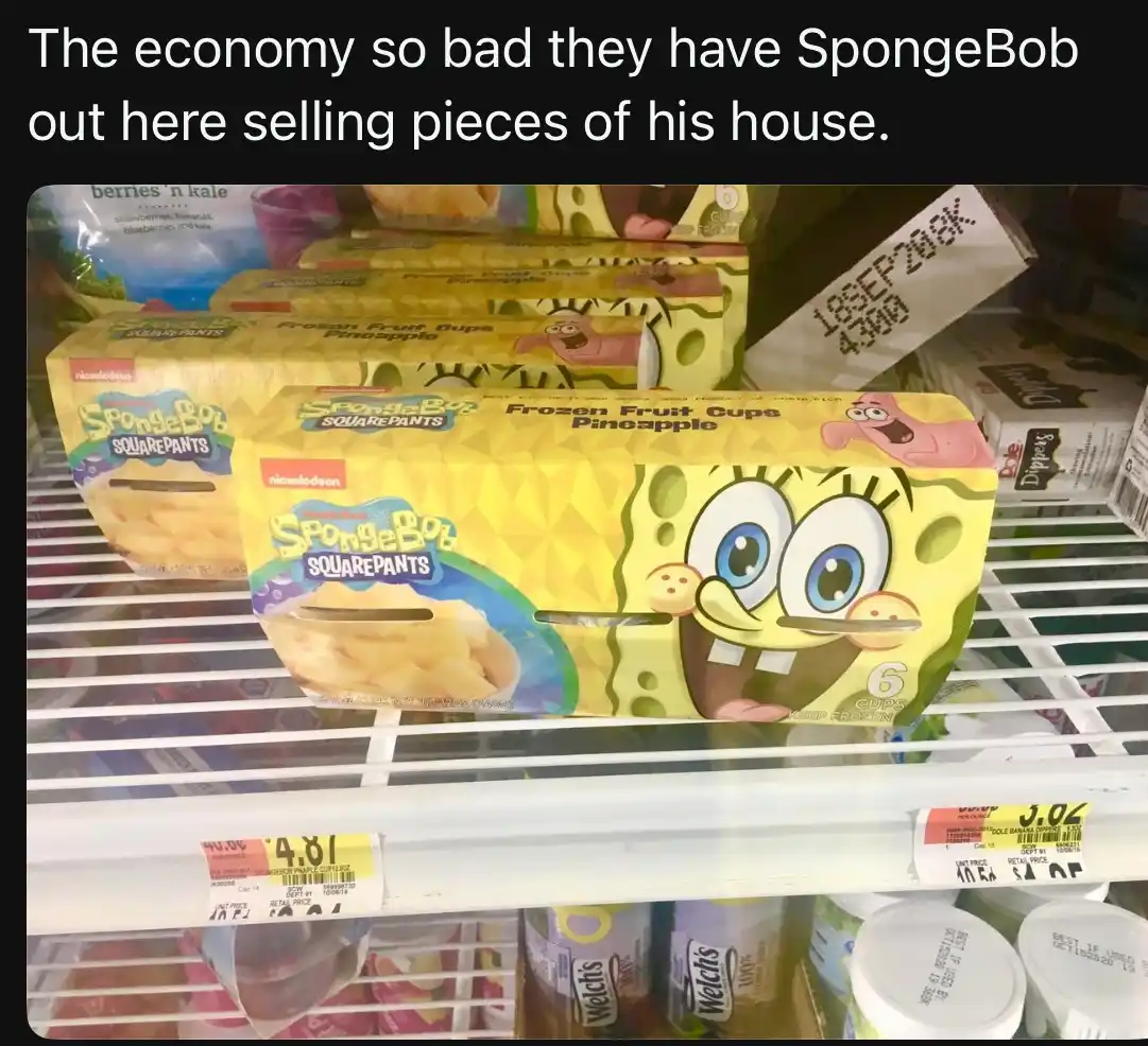 A photo of a grocery store freezer shelf displaying boxes of SpongeBob SquarePants branded frozen pineapple fruit cups. The…
