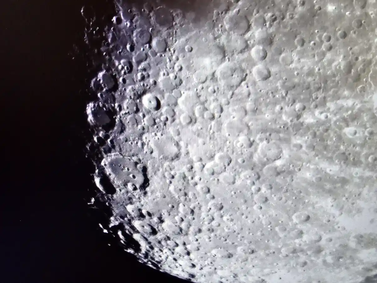 A close-up image of the moon's cratered surface against the blackness of space, with the overlaid text 'i'm not crying…