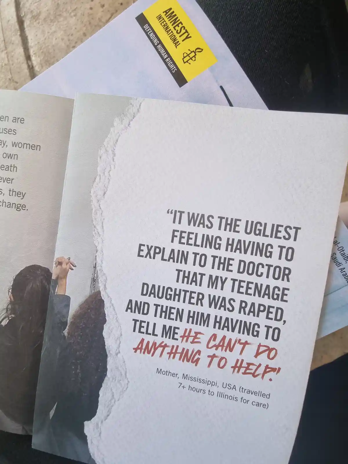 A close-up photo of an Amnesty International pamphlet featuring a quote from a mother in Mississippi, USA, describing the…
