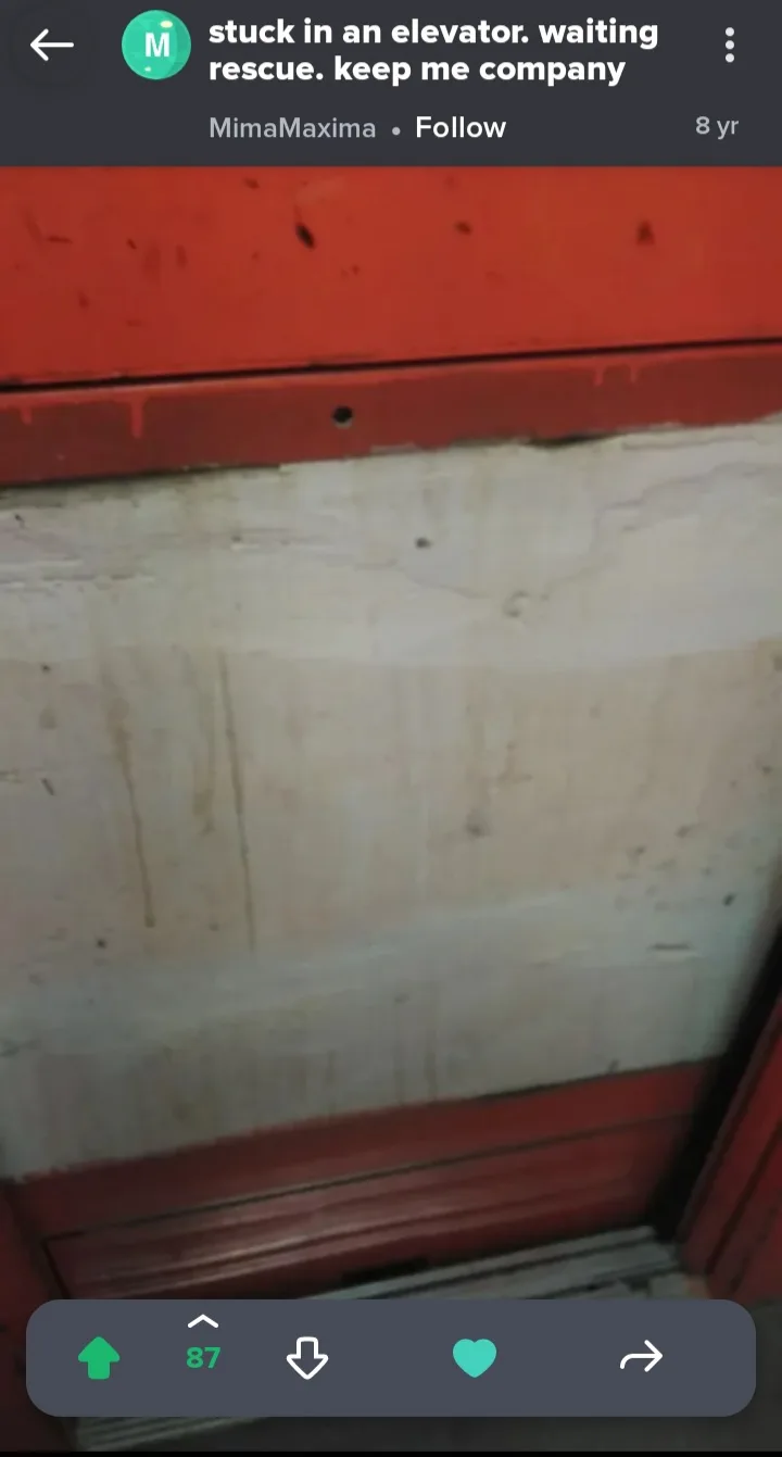 A low-resolution photo shows the interior of a dirty, grimy elevator with red-painted metal trim and a stained, cracked…