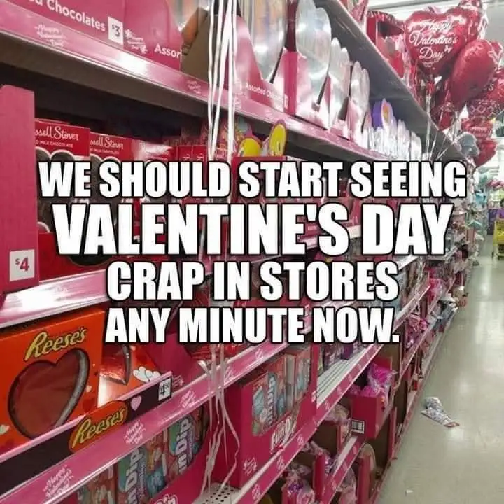 A photo of a supermarket aisle filled with Valentine's Day merchandise, including heart-shaped Reese's chocolates, pink…