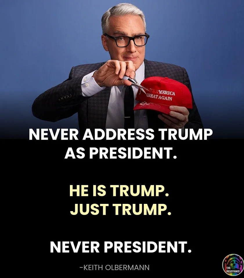 A man in a suit and glasses cuts a red 'Make America Great Again' cap with scissors. Text overlaid on a black background…