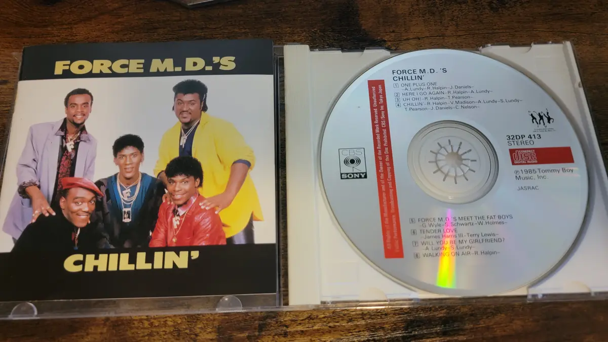 A photo of the 1985 Force M.D.'s CD 'Chillin'' with the album cover and disc open, showing the tracklist. The cover features…