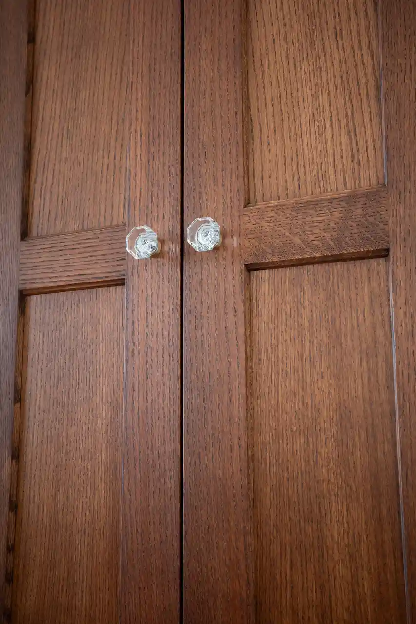 A close-up photo of two wooden doors with crystal doorknobs, overlaid with the text 'i'm not a door, i'm a door with a…