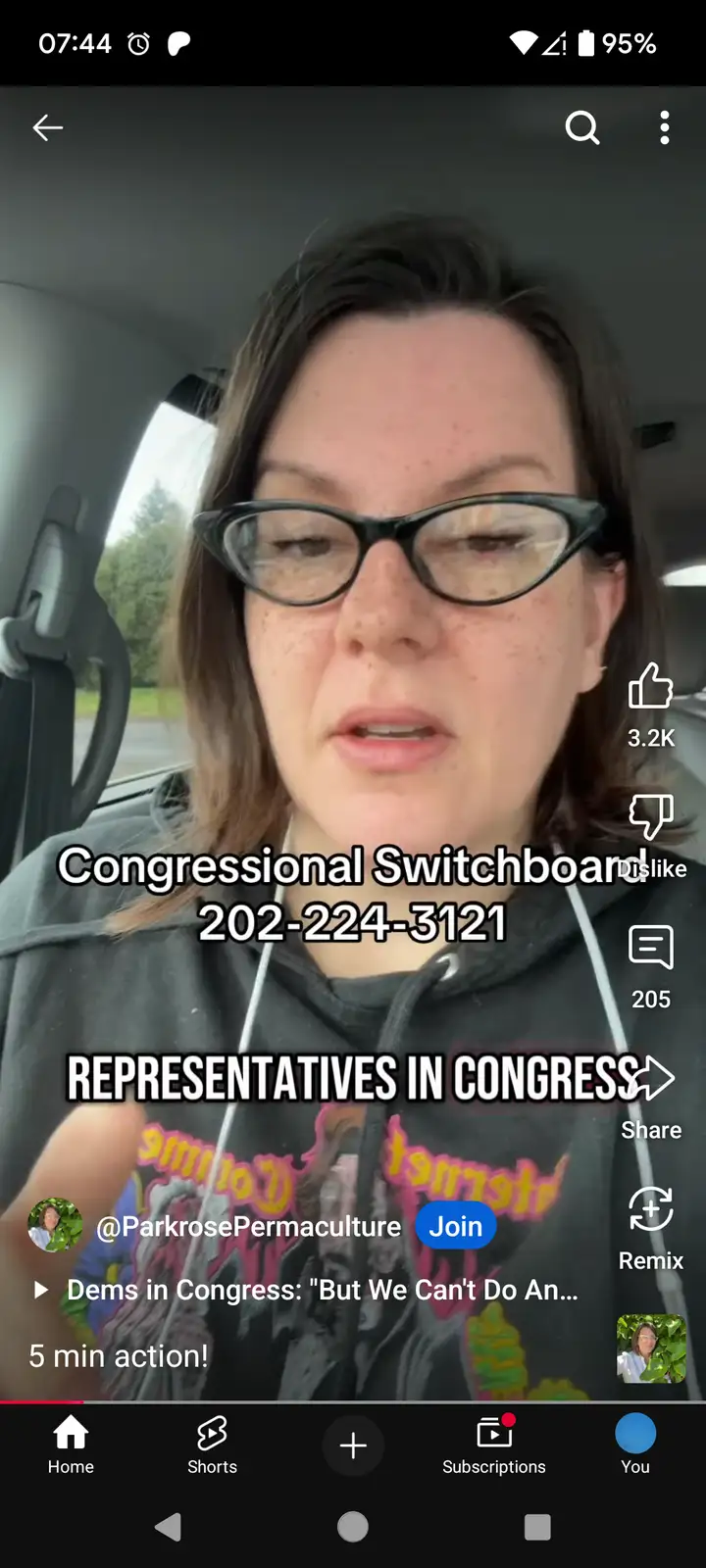 A woman with glasses and freckles is shown in a car, overlaid with text reading 'Congressional Switchboard 202-224-3121' and…