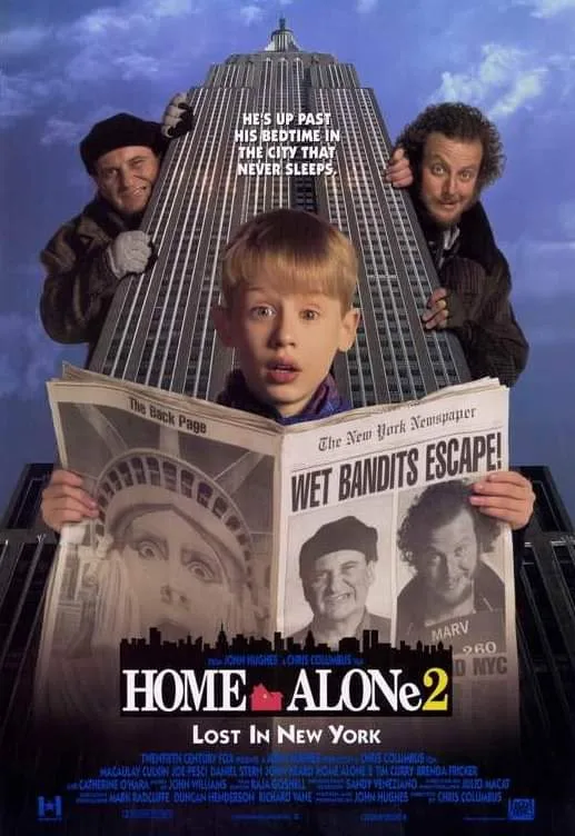 A movie poster for 'Home Alone 2: Lost in New York' shows a young boy holding a newspaper with 'WET BANDITS ESCAPE!' on the…