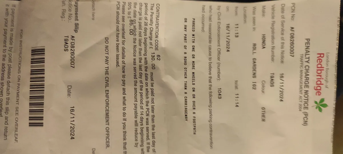 A close-up photo of a Redbridge London Borough Penalty Charge Notice (PCN) for parking on a footpath, showing the vehicle…