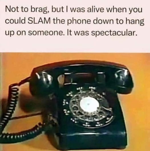 A black rotary telephone with its handset resting on the base, set against a plain orange background. The overlaid text…