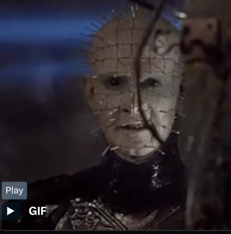 A close-up of the horror character Pinhead from the Hellraiser franchise, identifiable by his grid-patterned forehead and…