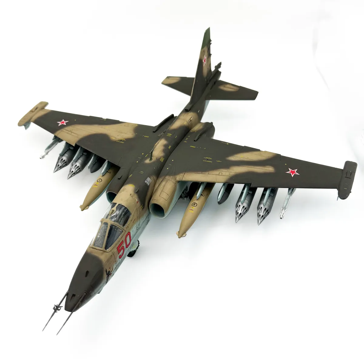 A highly detailed scale model of a Soviet-era fighter-bomber, likely a Su-24, is shown against a plain white background. The…