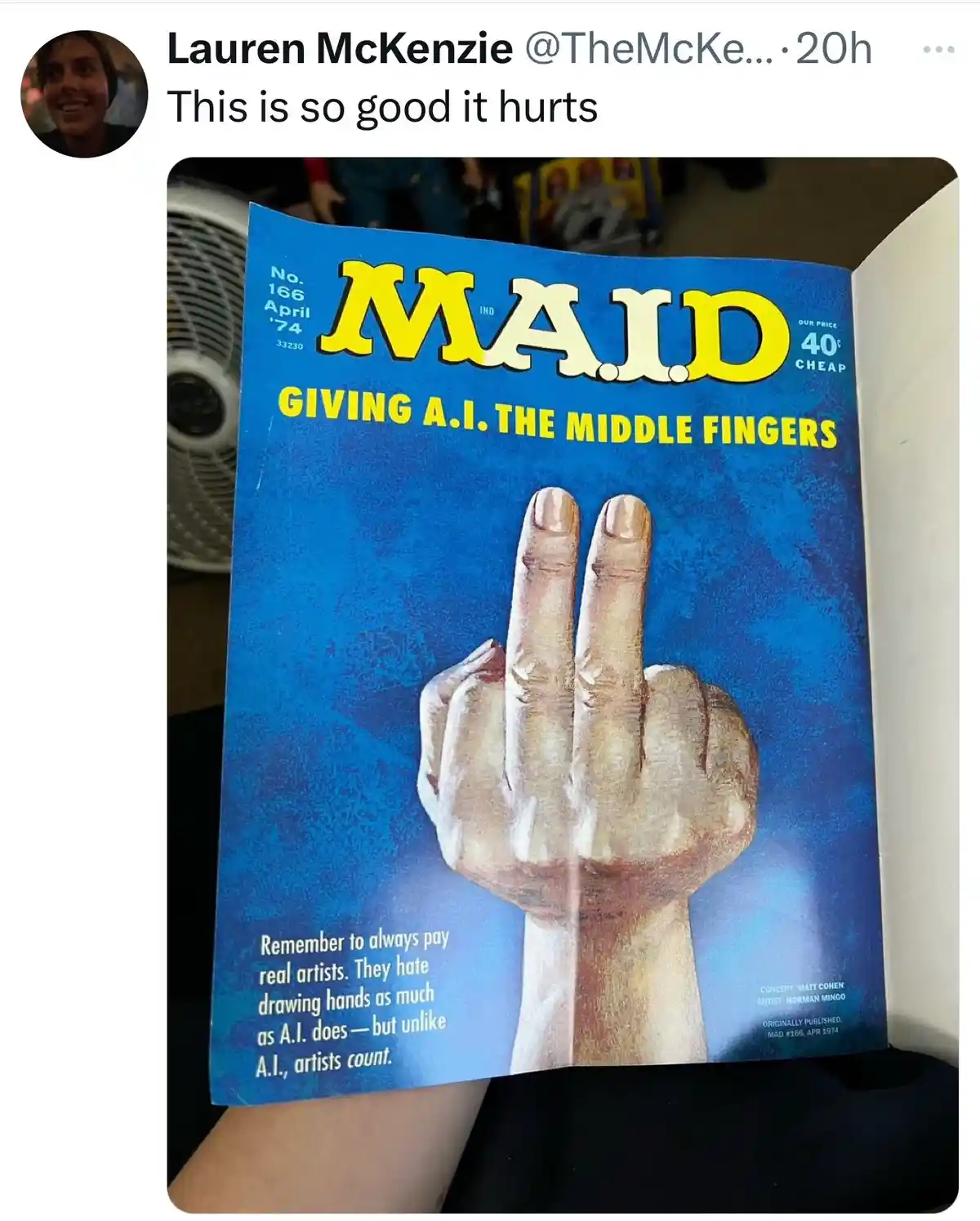 A person holds open a vintage MAD magazine, issue #166 from April 1974, featuring a large illustration of a hand giving the…