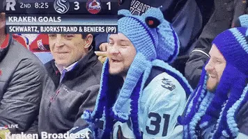 A sequence of six frames shows a hockey fan wearing a blue knitted hat with octopus tentacles and red eyes, reacting with…