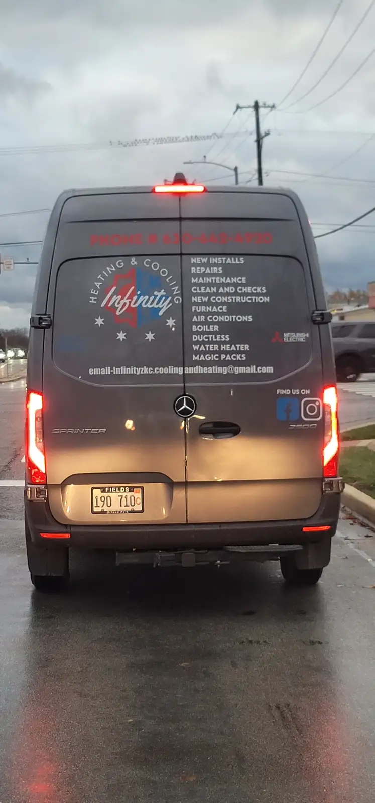The rear of a gray Mercedes-Benz Sprinter van with 'Heating & Cooling Infinity' branding and a list of services including…