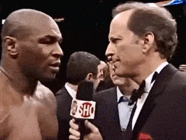 A six-panel image sequence from a 1990s boxing interview shows Mike Tyson being asked a question by a reporter holding a…