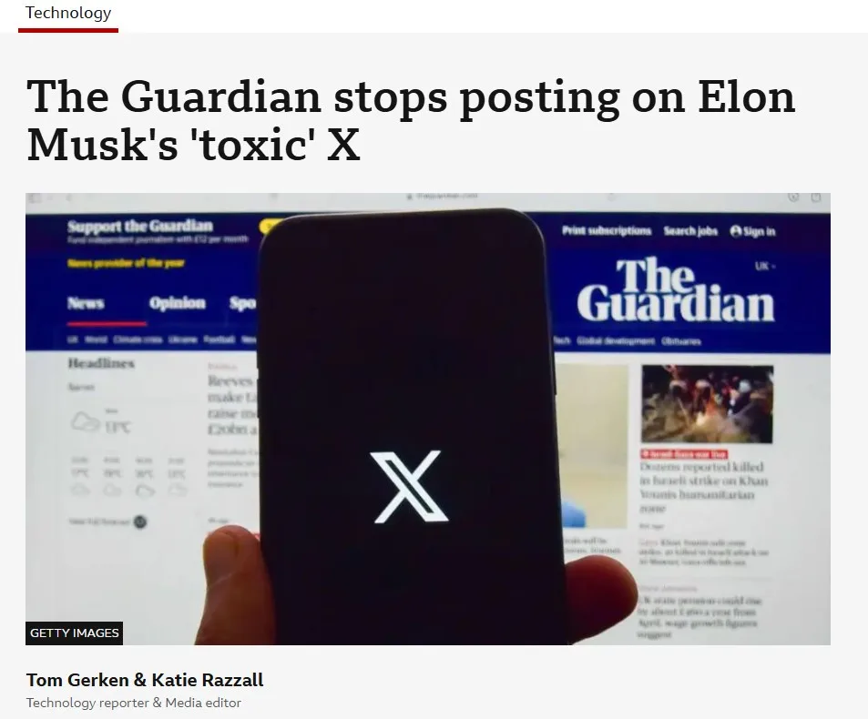 A hand holds a black smartphone displaying the white 'X' logo, obscuring a computer screen showing The Guardian's website…