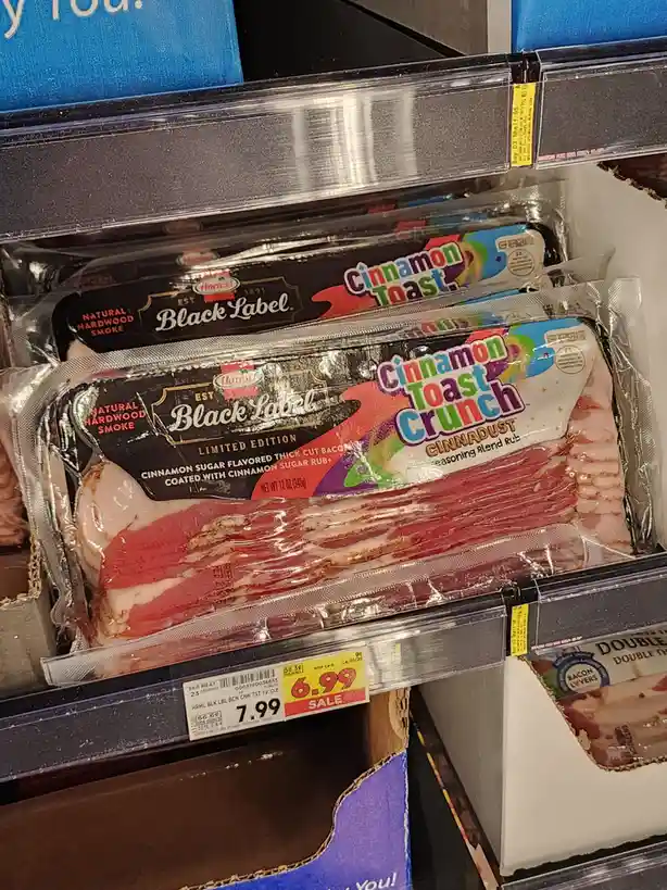 A close-up photo of a package of Hormel Black Label bacon labeled 'Cinnamon Toast Crunch' seasoning blend rub, displayed on…