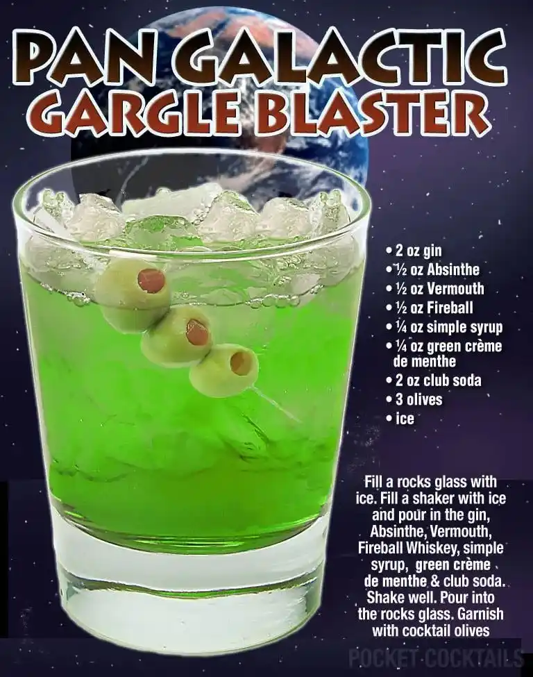 A vibrant green cocktail in a rocks glass filled with ice and garnished with three olives, set against a space-themed…
