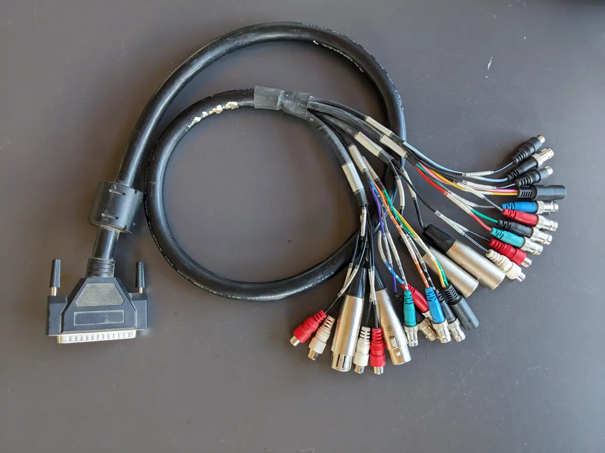 A single black DVI cable is shown coiled on a dark surface, with one end featuring a standard DVI connector and the other…