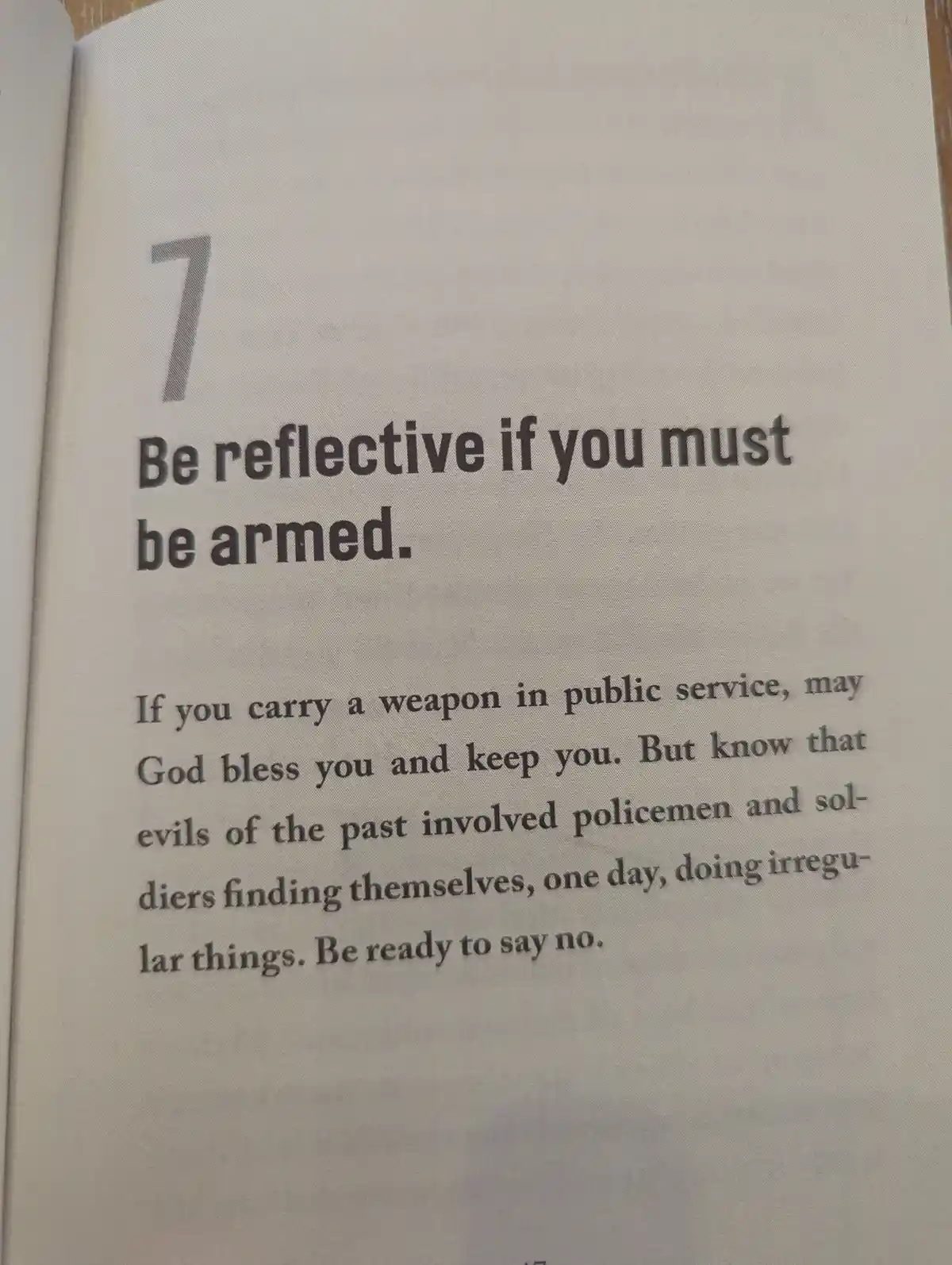 A close-up photo of a book page showing a numbered section titled '7 Be reflective if you must be armed.' The text below…