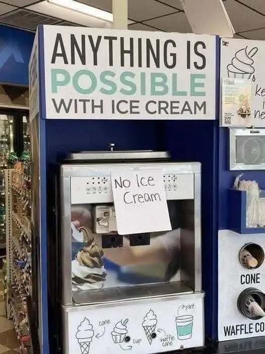 A photo of a self-serve ice cream machine with a large sign above reading 'ANYTHING IS POSSIBLE WITH ICE CREAM'. A…
