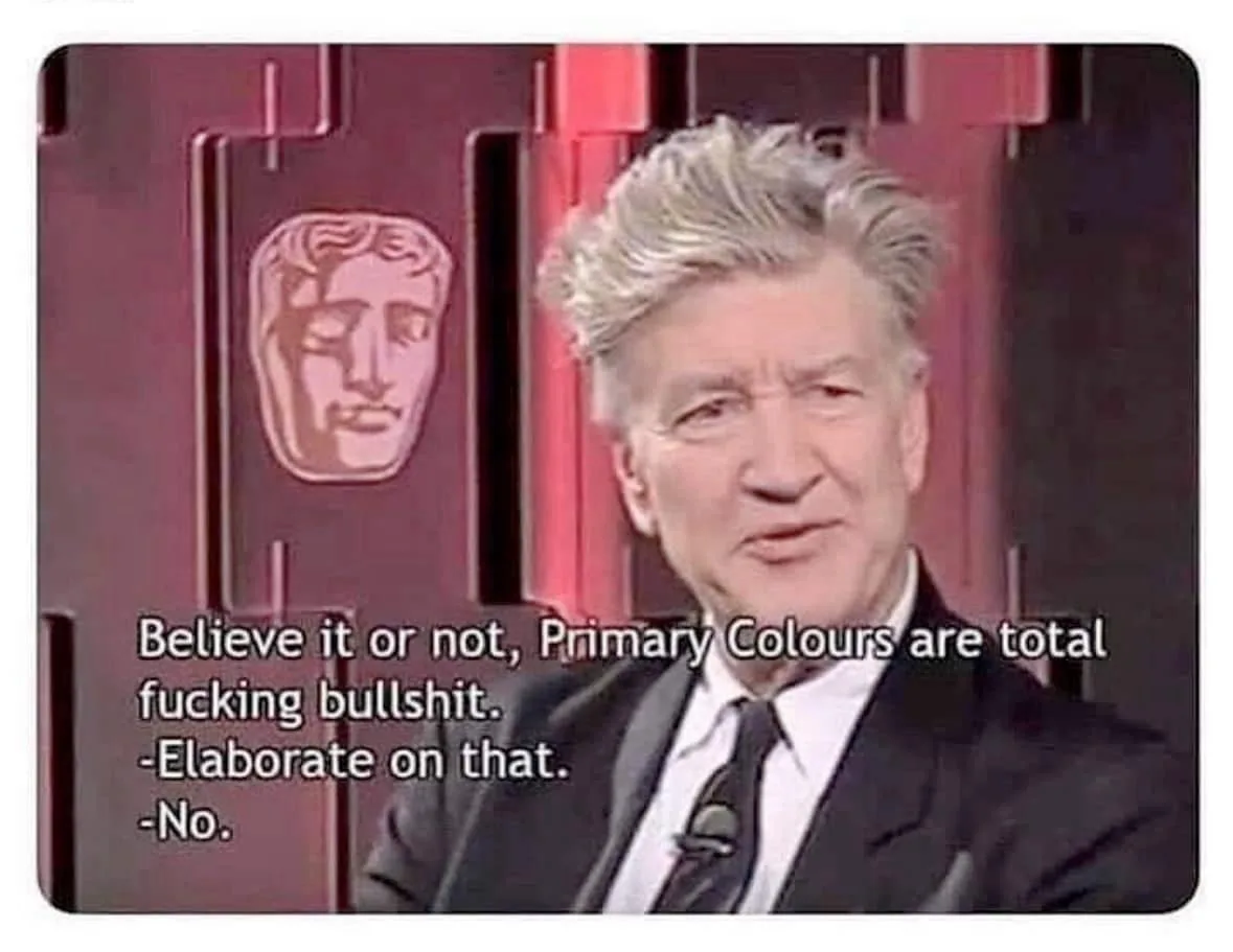 A man with gray hair in a suit and tie is shown in a red-lit studio with a BAFTA logo behind him. The overlaid text reads…