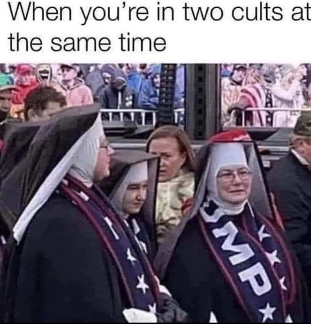 Two nuns wearing patriotic sashes, one with 'TRUMP' in large white letters and stars, stand side by side while a woman in…