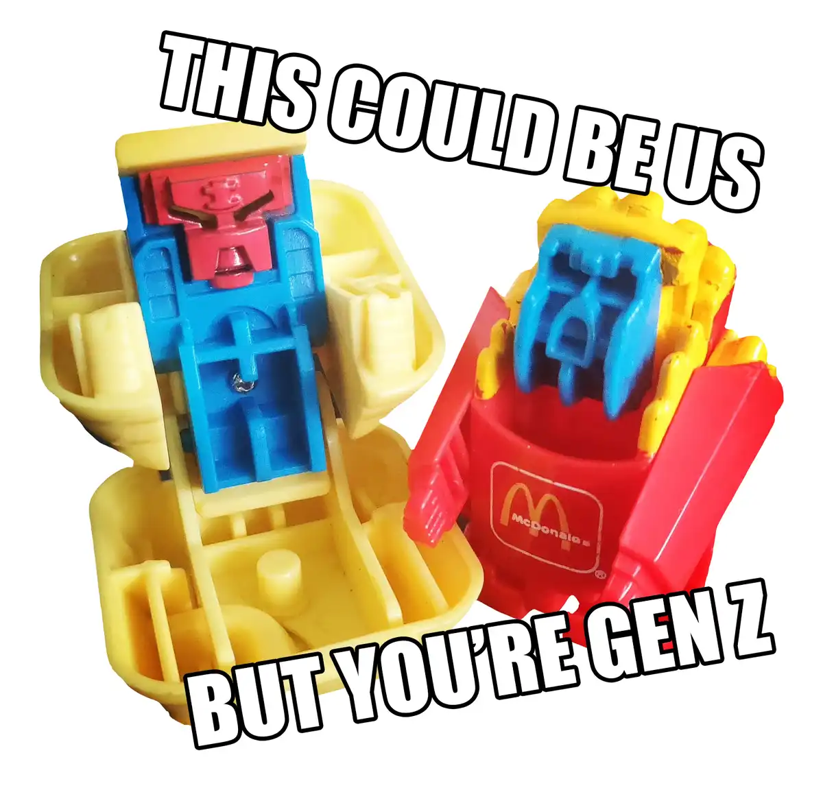 Two McDonald's Happy Meal toys, one resembling a robot and the other a french fry container with a blue robot head, are…