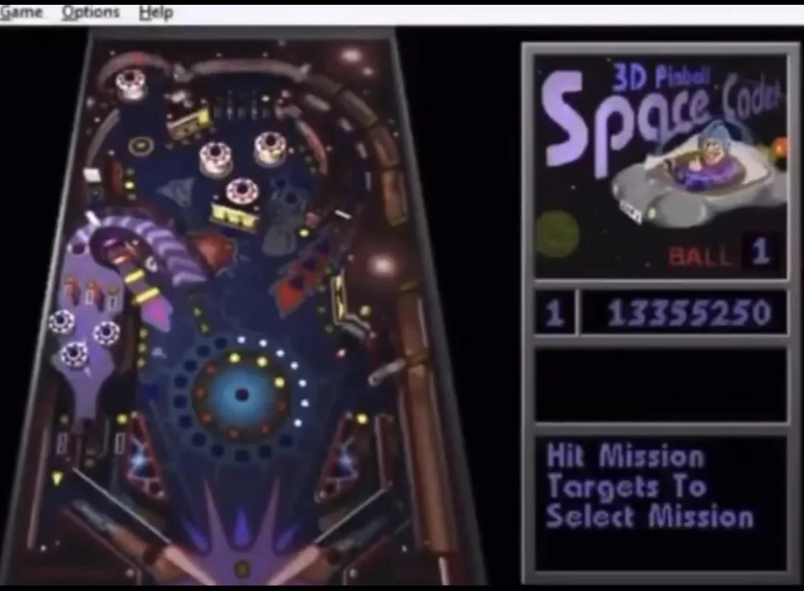 A screenshot of the video game '3D Pinball Space Cadet' showing a space-themed pinball table with glowing targets and a…