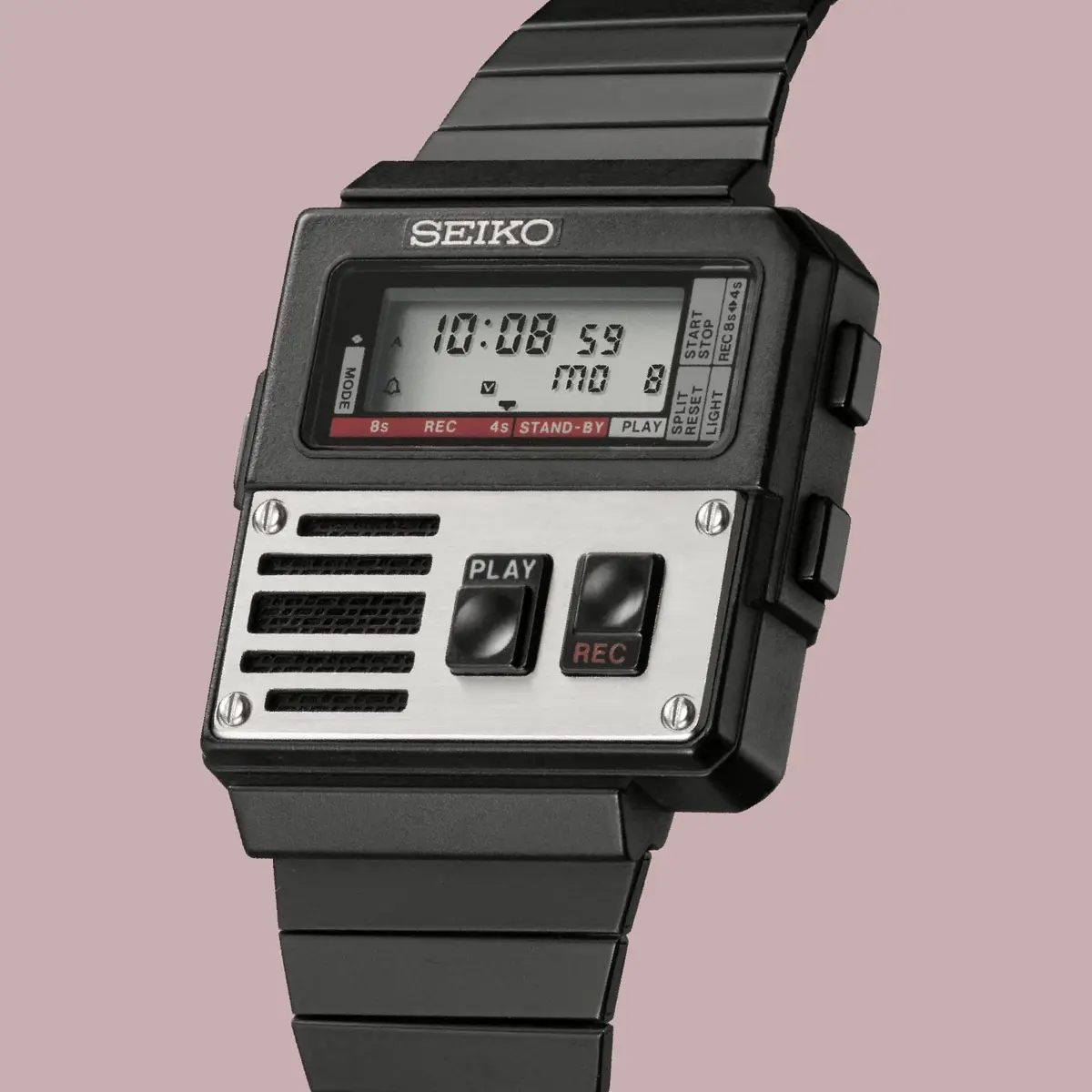 A black Seiko digital watch with a unique design resembling a portable cassette player, featuring a silver panel with…