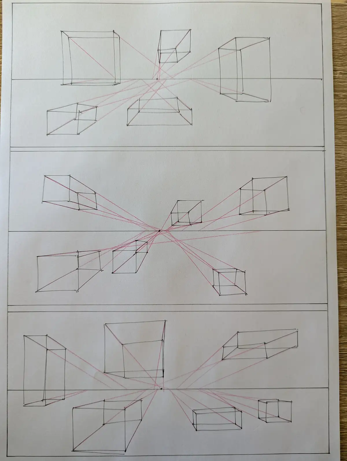 The image displays three horizontal sections of a hand-drawn page, each containing multiple hand-drawn cubes in perspective…