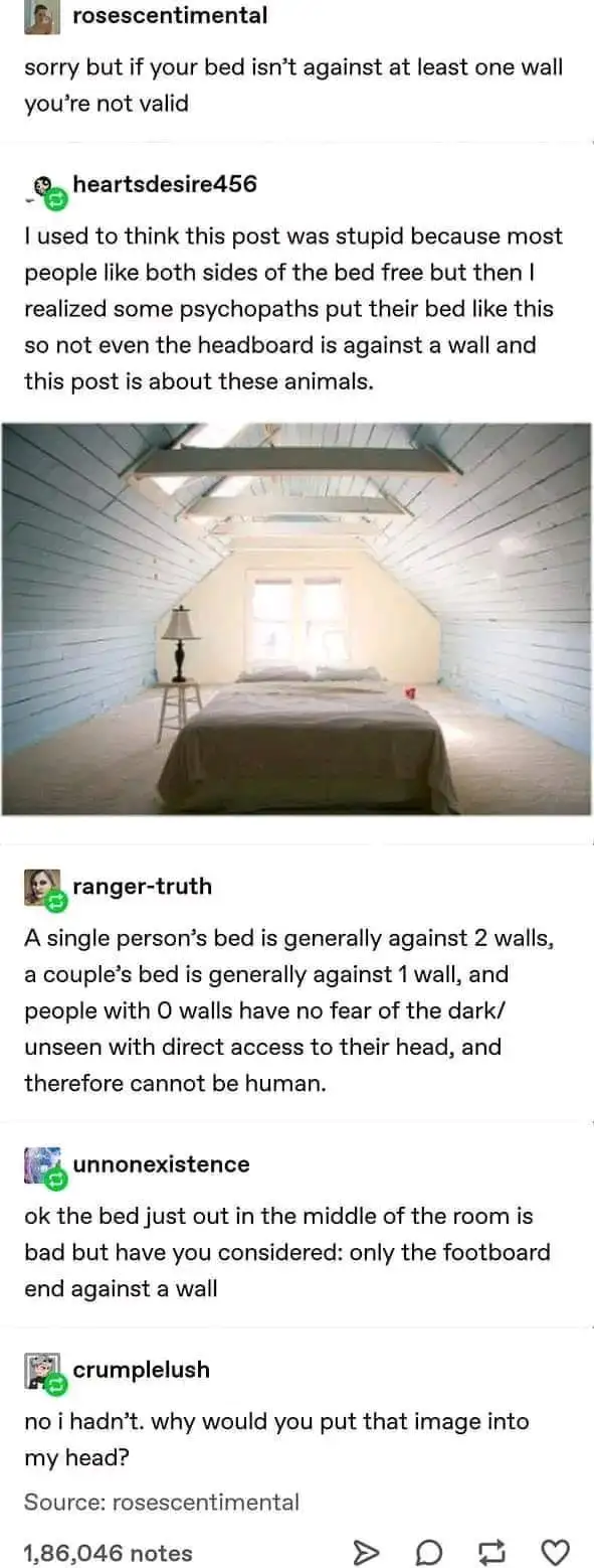 A photo of a bed placed in the center of a room with sloped ceilings, not touching any walls. The overlaid text reads 'sorry…
