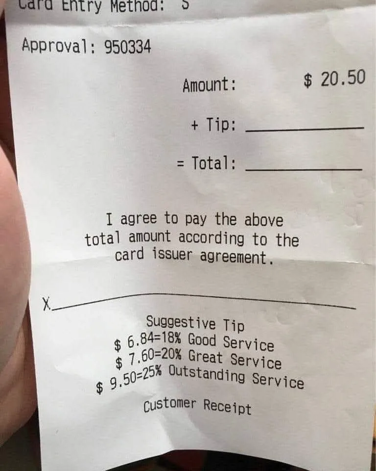 A close-up photo of a restaurant receipt showing a $20.50 bill with a blank tip line and a checkbox marked with an 'X' next…
