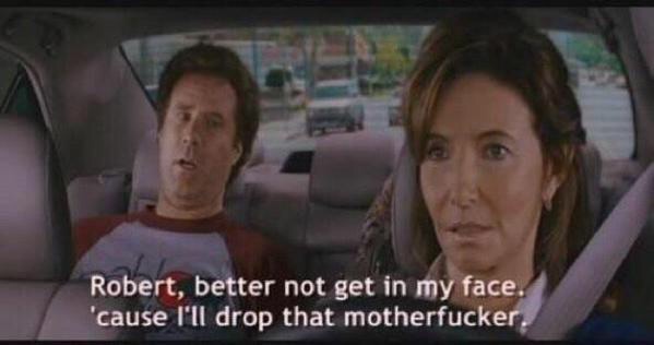 A still from a movie shows a man and a woman in a car. The man in the passenger seat looks surprised, while the woman in the…