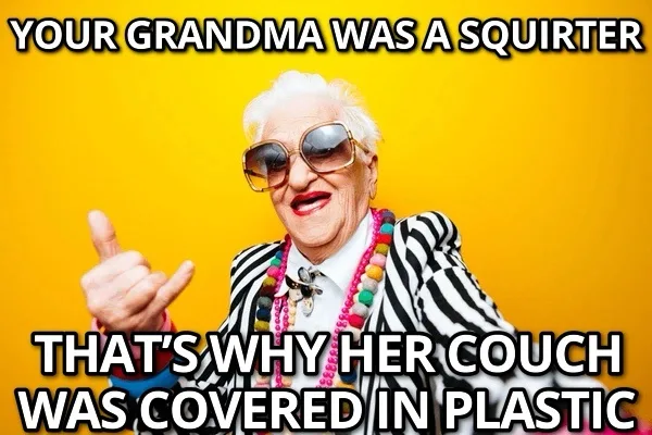An elderly woman with white hair, wearing large sunglasses, a zebra-striped jacket, and colorful beaded necklaces, gives a…