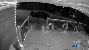 A six-panel security camera sequence shows a man walking up to a fence at night. The camera briefly goes blurry, then clears…