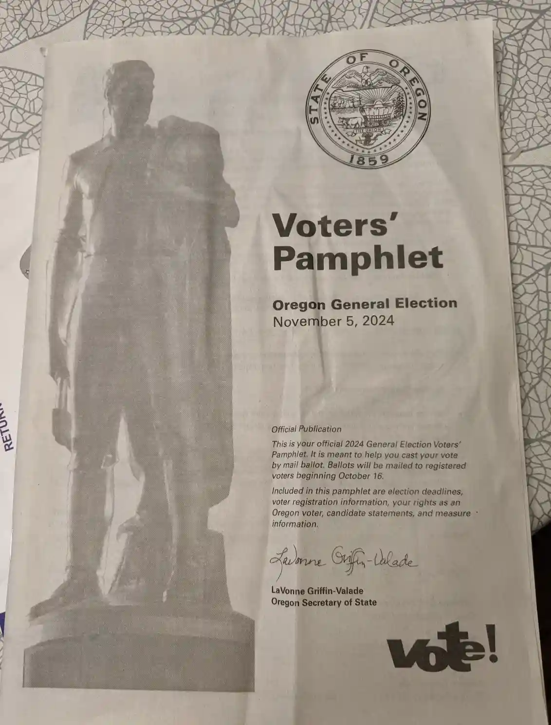 A grayscale image of an official Oregon Voters' Pamphlet for the November 5, 2024, General Election, featuring a statue on…