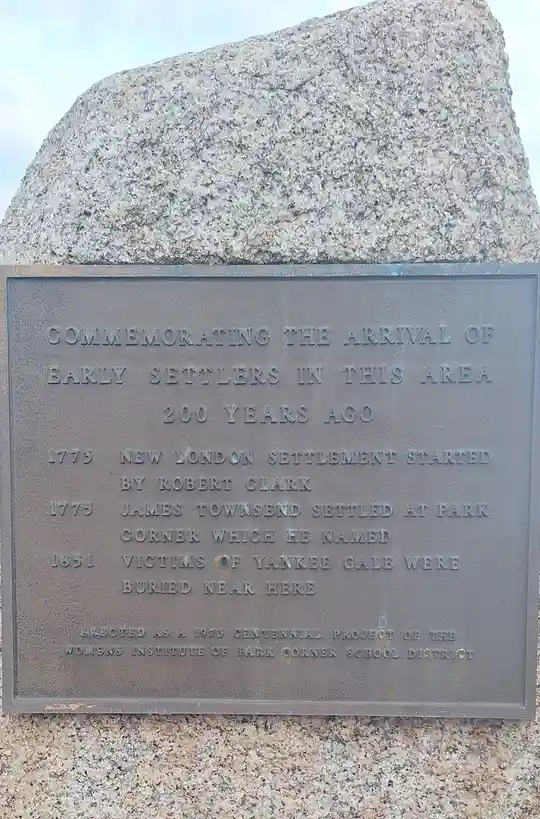 A close-up of a bronze historical plaque mounted on a granite monument, commemorating early settlers in the area 200 years…
