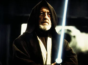 a still image of the character obi-wan kenobi from star wars, wearing his dark robe and hood, holding a blue lightsaber…