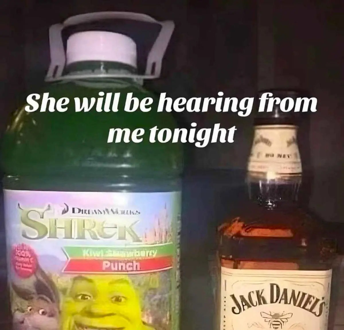 A large green bottle of Shrek Kiwi Strawberry Punch sits next to a bottle of Jack Daniels whiskey inside a refrigerator…