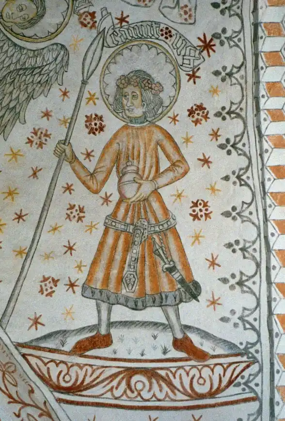 A medieval-style stained glass or wall painting depicts a haloed figure identified as Saint George, holding a lance and a…