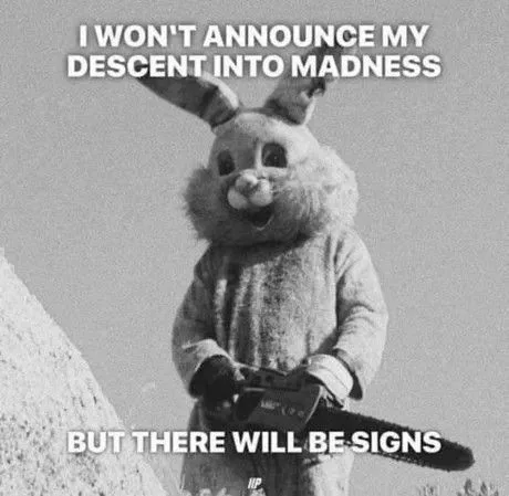 A black-and-white image shows a person in a full bunny costume holding a chainsaw, standing on a snowy slope. The text…