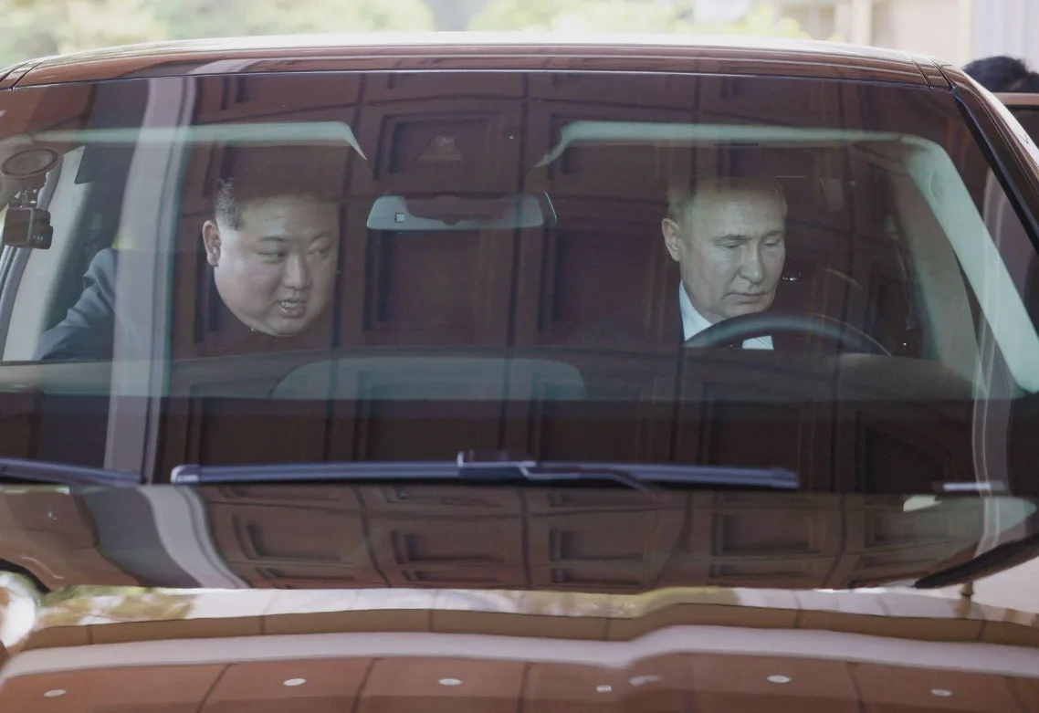 A photo shows Kim Jong Un in the front passenger seat of a luxury car while Vladimir Putin is in the driver's seat, both…