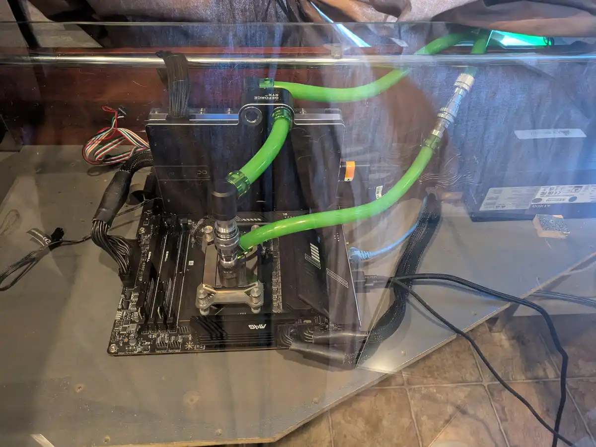 A custom-built computer with a liquid cooling system featuring bright green tubes connected to a graphics card and…