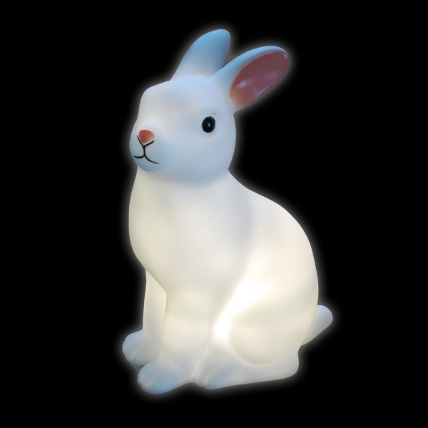 A white, glowing rabbit-shaped lamp with pink inner ears and black eyes sits against a black background. The overlaid text…