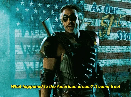 A six-panel meme showing the character Ra's al Ghul from Batman: The Dark Knight Rises, with an American flag graffiti…