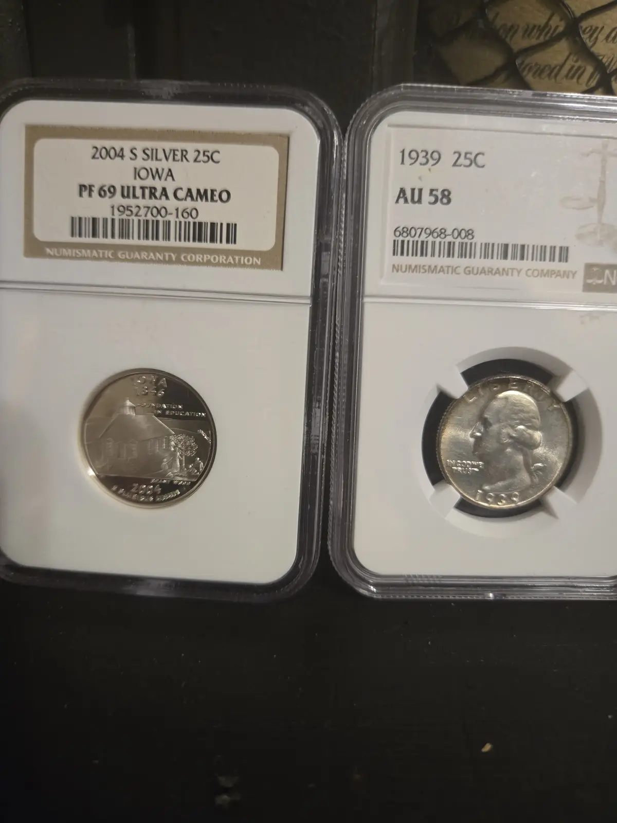Two U.S. quarters in protective slabs from Numismatic Guaranty Corporation are displayed side-by-side. The left slab…
