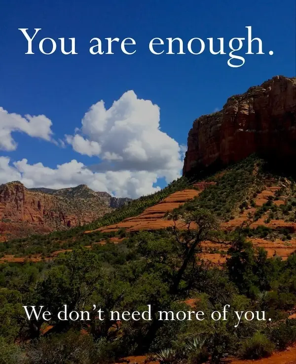 A scenic desert landscape with red rock formations, green shrubs, and a blue sky with white clouds. White serif text…