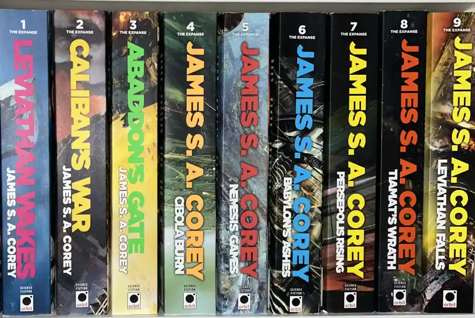 A row of nine science fiction paperback books by James S. A. Corey, titled 'The Expanse' series, numbered 1 through 9…